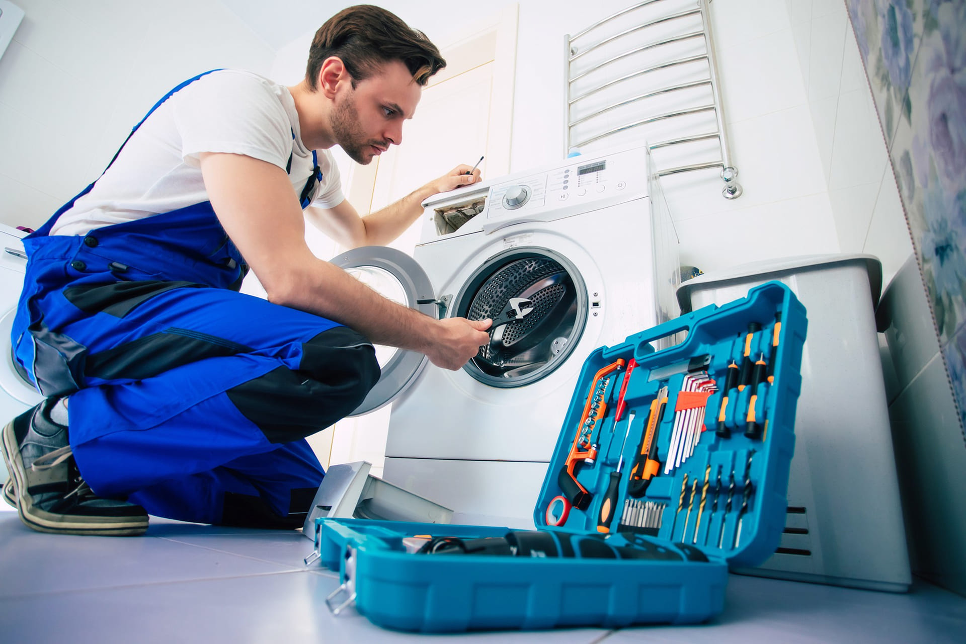 young-handsome-repairman-worker-suit-with-professional-tools-box-is-fixing-washing-machine-bathroom (1)